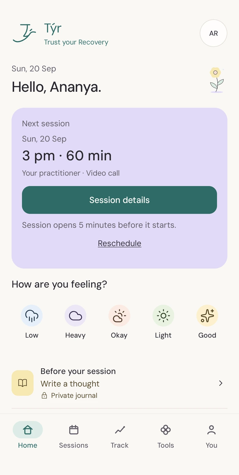 Týr Android Home screen with a soft paper background, a small flower, lilac appointment card, five mood choices, journal shortcuts, and Home, Sessions, Track, Tools and You tabs.